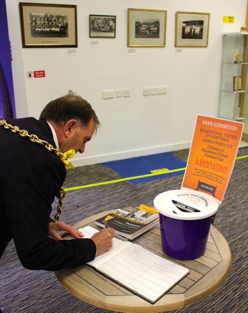 Maidstone Mayor Cllr Derek Mortimer signs visitors book
